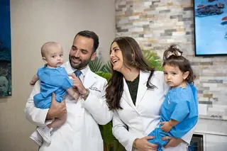 Dr. Joel Baez and Dr. Valentina Baez with their children at the practice.