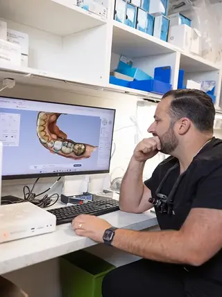 A full-arch case being designed on screen at Signature Dental Group.